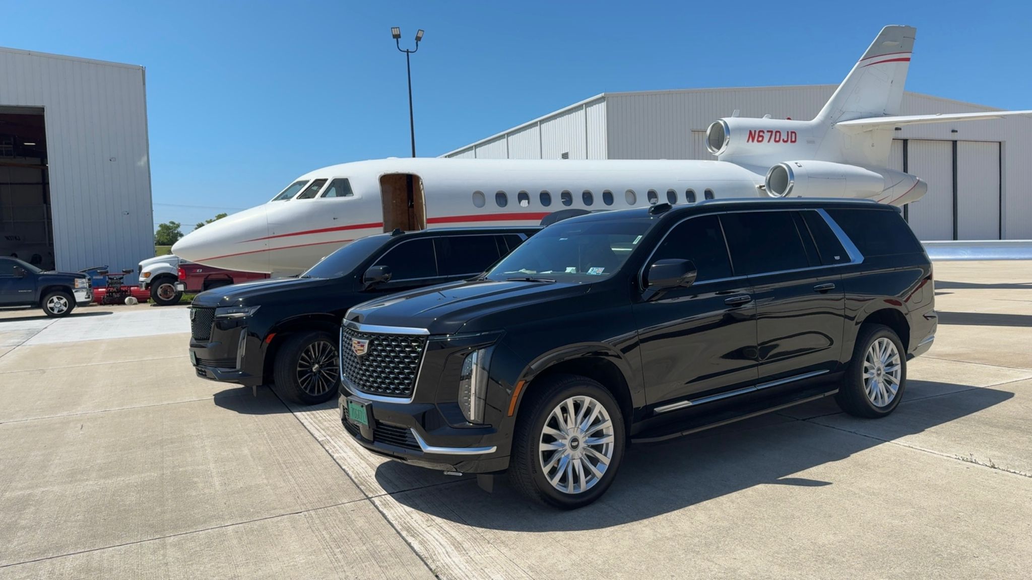 Cadillac Escalade luxury SUVs at private aviation terminal